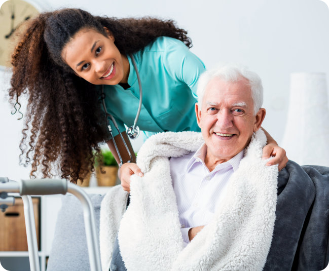 a female nurse with an elderly man smiling