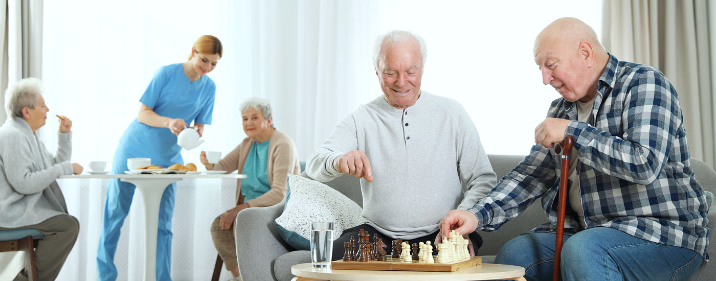 elderly playing chess and eating food