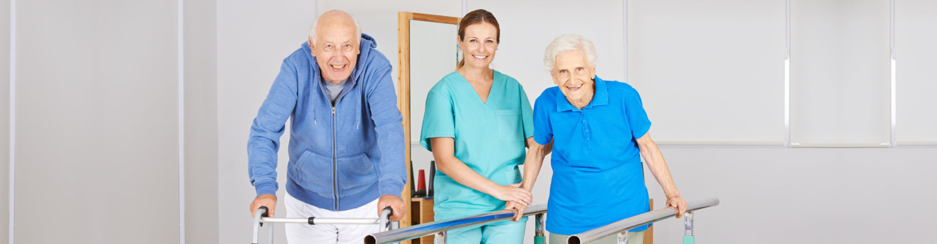 Two senior people doing walking exercise in physiotherapy with physiotherapist